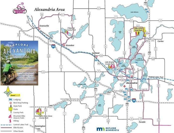 Map of the Alexandria Area, Minnesota, showing highways, local roads, lakes, parks, bike trails, and key attractions. An inset features a cyclist promoting the Bike Map and exploring Alexandria. Includes legend for lodging, parks, trails, and lakes.