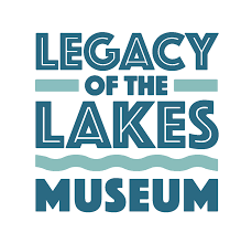 Logo for Legacy of the Lakes Museum featuring bold teal and blue text, with stylized waves flowing beneath the word "LAKES.