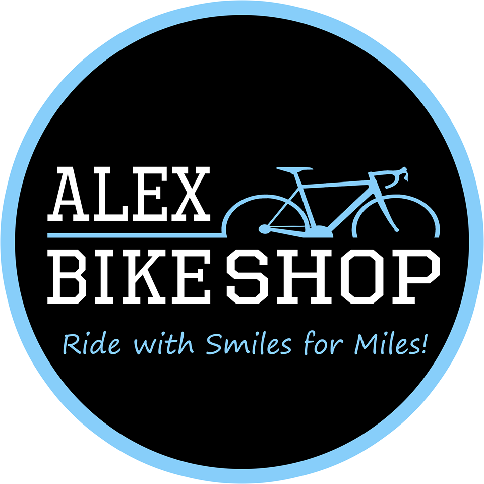 Logo for Alex Bike Shop features a blue-outlined black circle with a blue bicycle graphic and the text "ALEX BIKE SHOP" in white. Below, blue text reads, "Ride with Smiles for Miles!"—capturing Alex Bike Shop's fun spirit.