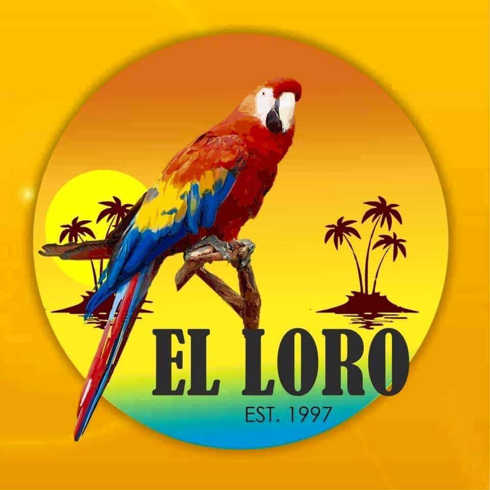 A colorful parrot sits on a branch in front of a yellow sunset with palm trees. The text "El Loro EST. 1997" appears at the bottom, capturing the vibrant spirit of El Loro’s tropical charm.
