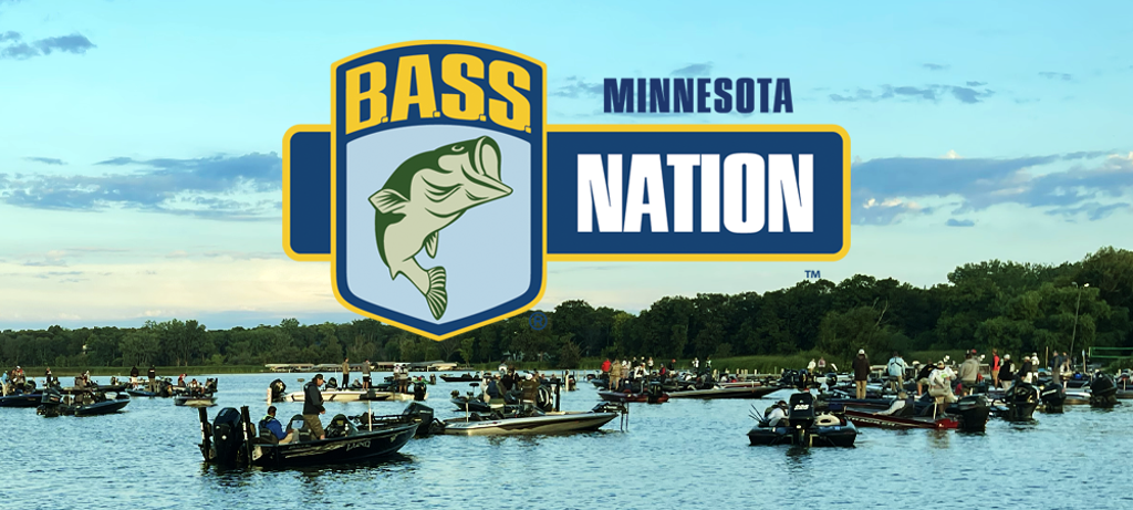 A large group of people in fishing boats gathers on a lake with trees in the background. The MN BASS Nation 50th Anniversary "Tournament of Champions" logo featuring a fish is prominently displayed in the center of the image.