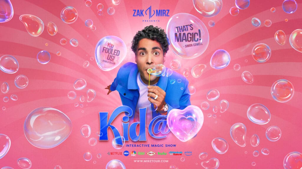 A man in a blue jacket blows bubbles against a pink, bubble-filled background. Text reads "Kid@", "Interactive Magic Show," featuring Magician Zak Mirz, with quotes “That's Magic!” and “You Fooled Us!” inside some bubbles.
