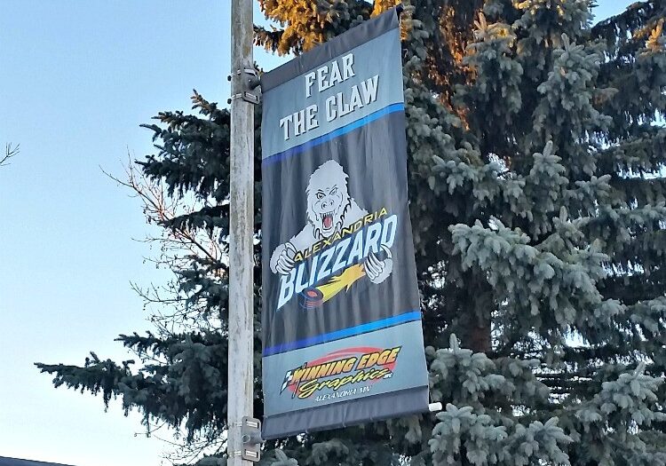 A street banner reads "FEAR THE CLAW" above a fierce Alexandria Blizzard white bear mascot and the words "ALEXANDRIA BLIZZARD," with evergreen trees in the background. The bottom features the logo "CUTTING EDGE SYNTHETICS.