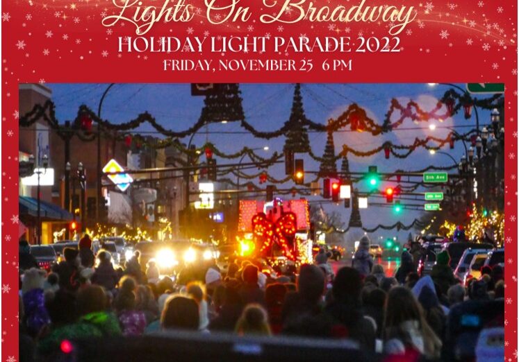 A festive crowd watches brightly lit floats during the "Light Up Broadway" Holiday Light Parade 2022, with colorful street decorations and signs visible. Event details are displayed in white text on a red snowy border.