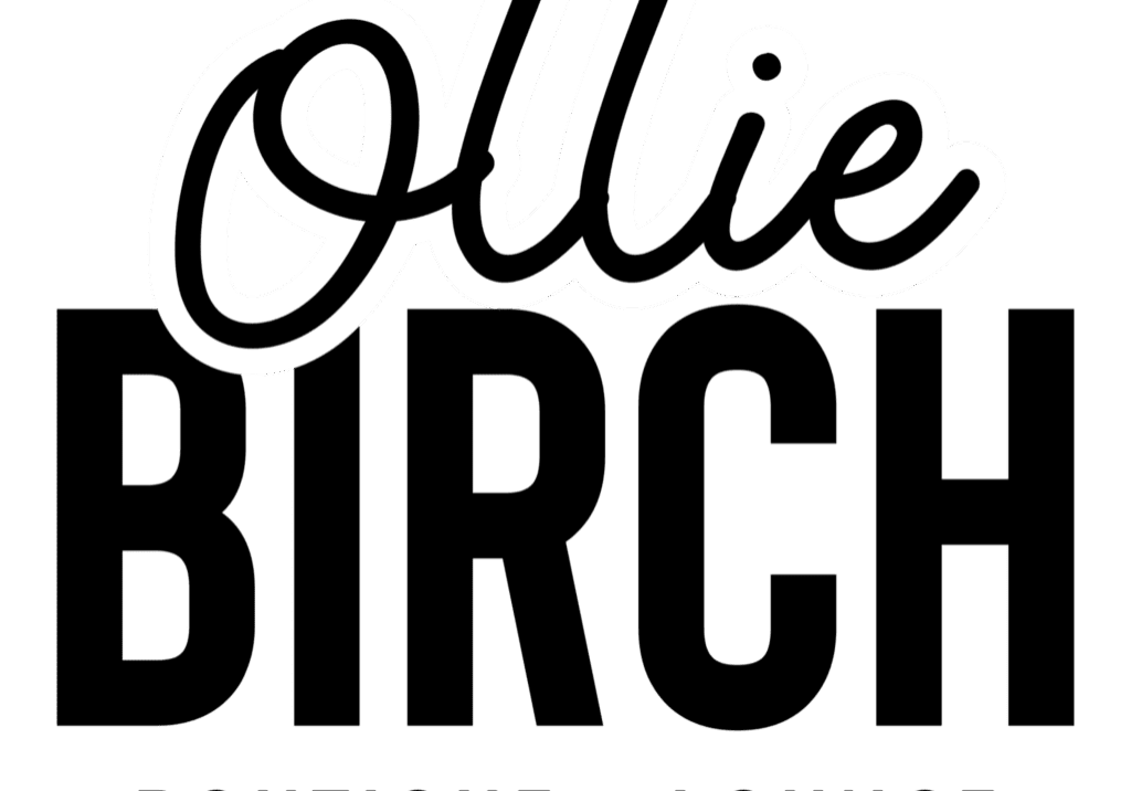 The word "Ollie" is written in bold, white, cursive letters with a black outline on a transparent background, capturing the chic and modern vibe of Ollie Birch Boutique + Lounge.