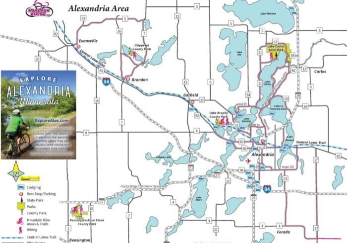 Map of the Alexandria Area, Minnesota, showing highways, local roads, lakes, parks, bike trails, and key attractions. An inset features a cyclist promoting the Bike Map and exploring Alexandria. Includes legend for lodging, parks, trails, and lakes.
