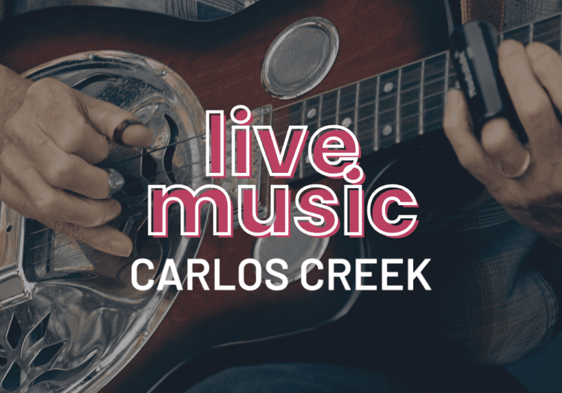 Close-up of a person playing a resonator guitar in a plaid shirt. Bold white and pink text reads "Live Music CARLOS CREEK," capturing the vibe of a Saturday afternoon filled with great tunes.