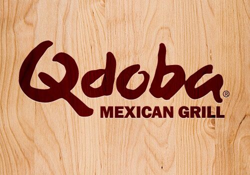 The Qdoba logo in bold dark red letters is displayed on a light woodgrain background, reflecting the fresh and vibrant spirit of Qdoba Mexican Grill.