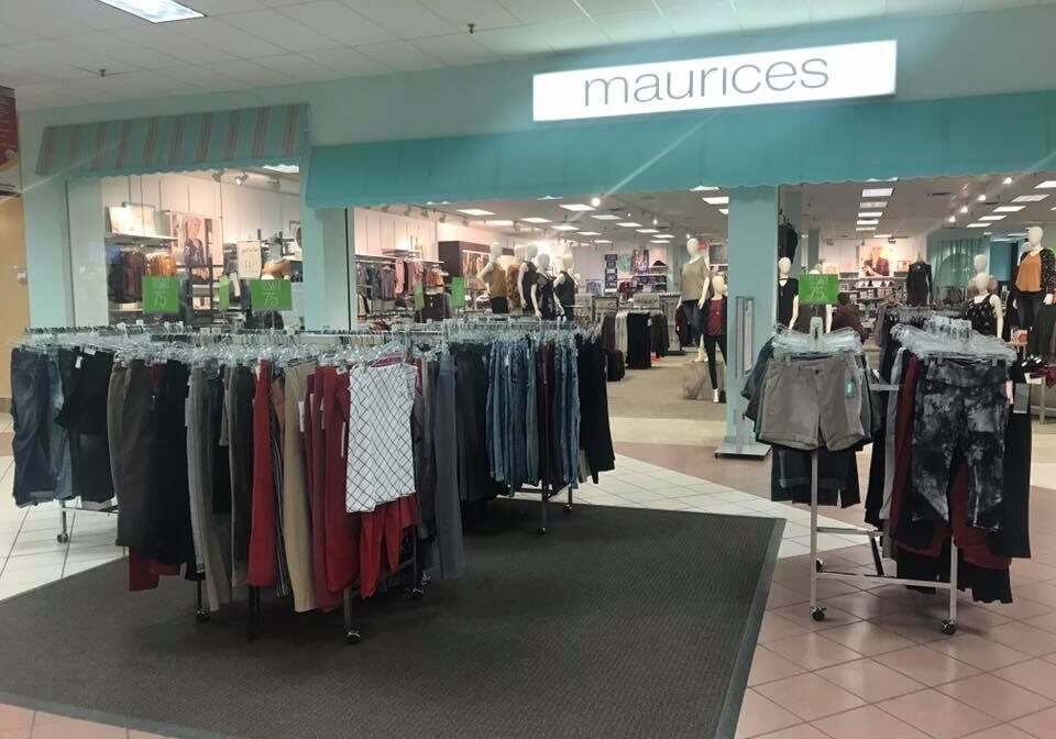 Clothing racks with pants and shorts are displayed at the entrance of a Maurices store in Viking Plaza Mall. The store interior is visible with more clothing and mannequins in the background.